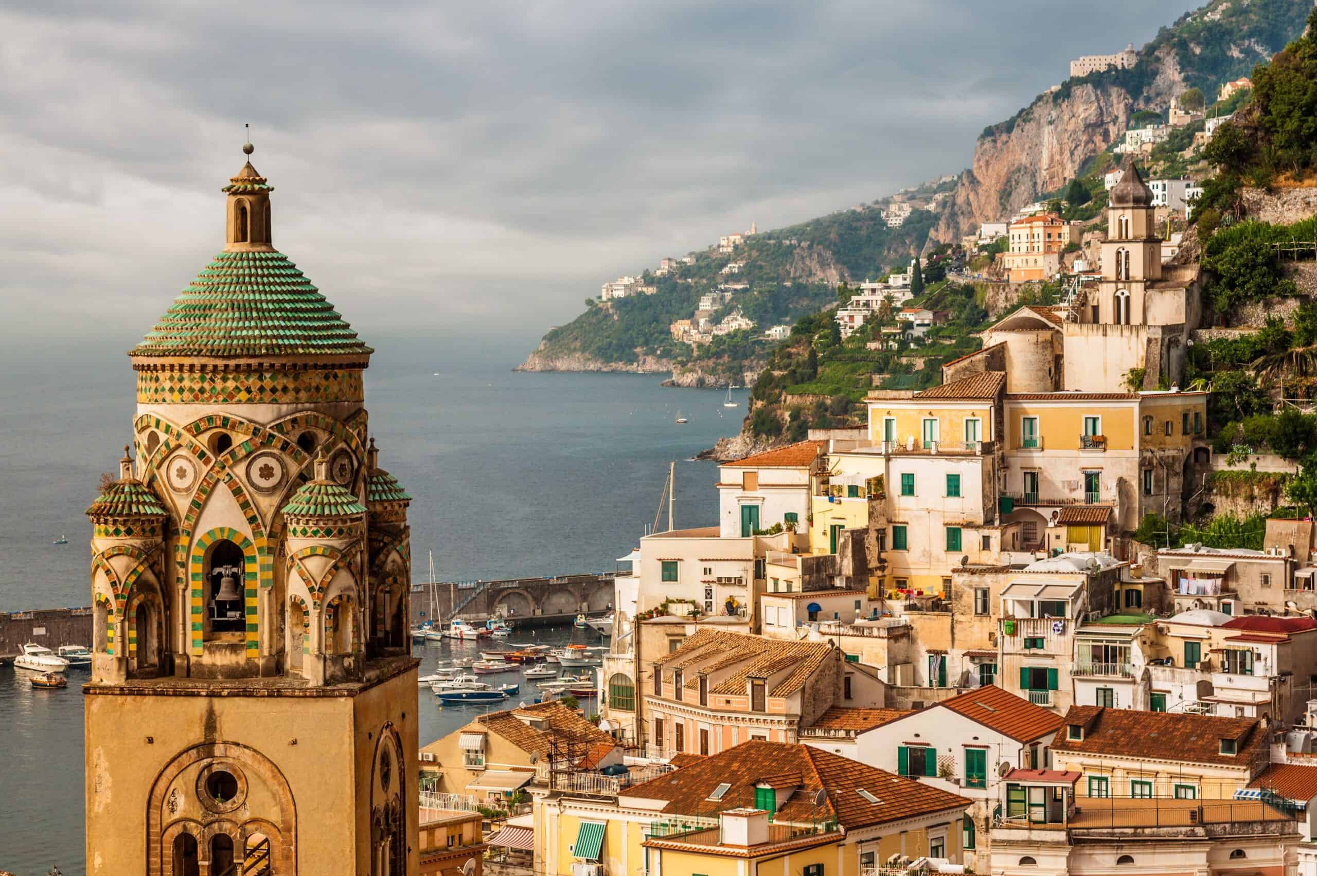 Colorful Amalfi Coast seaside village with historic architecture, vibrant buildings, and scenic hillside views in Italy.