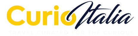 Curio Italia logo featuring vibrant yellow and elegant navy blue typography, representing a travel brand dedicated to curated Italian experiences.