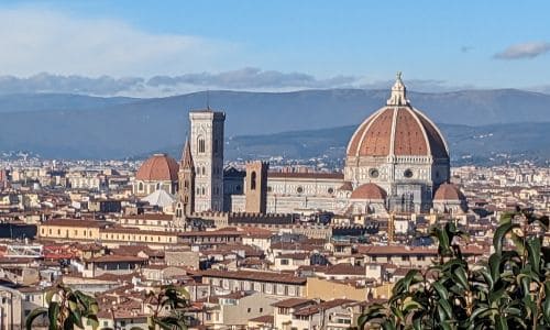 Panoramic view of Florence with the iconic Florence Cathedral (Duomo) and historic city rooftops, showcasing Italy's rich architectural heritage and vibrant urban landscape.